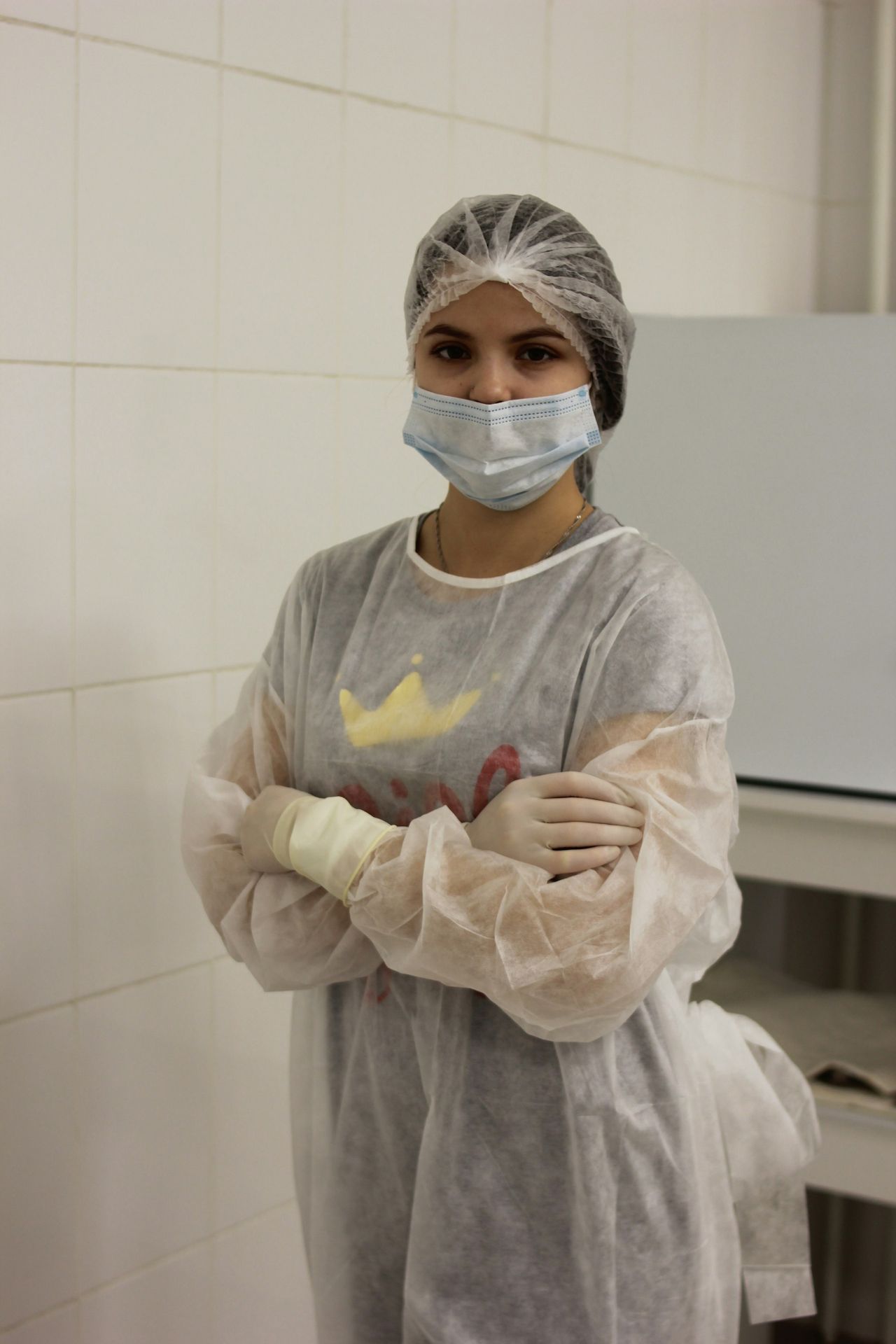 a woman wearing a surgical mask and gloves